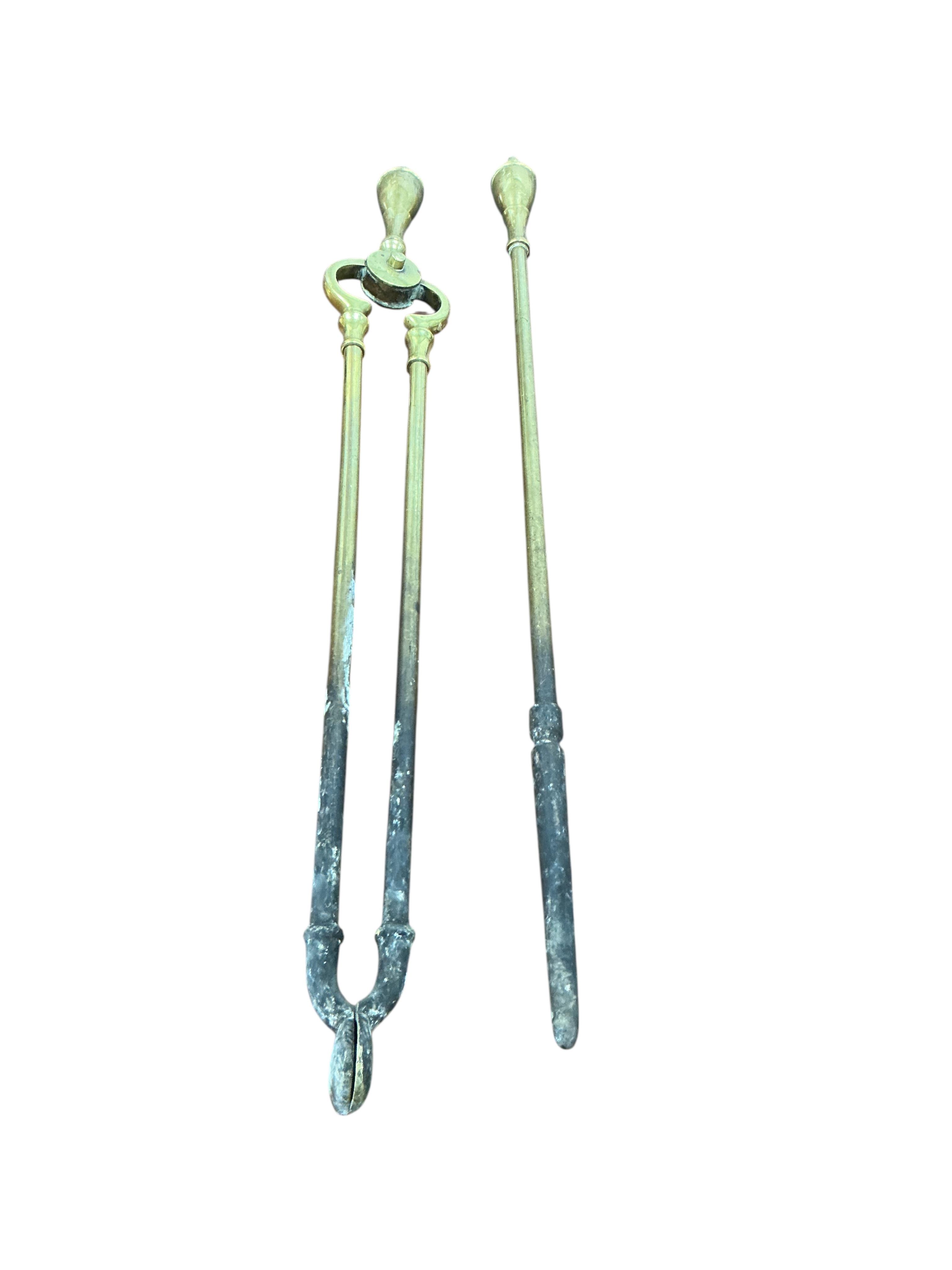 Two 19th century French iron mounted measures, diameter 30cm, height 33cm together with two Victorian brass fenders and two brass fire implements